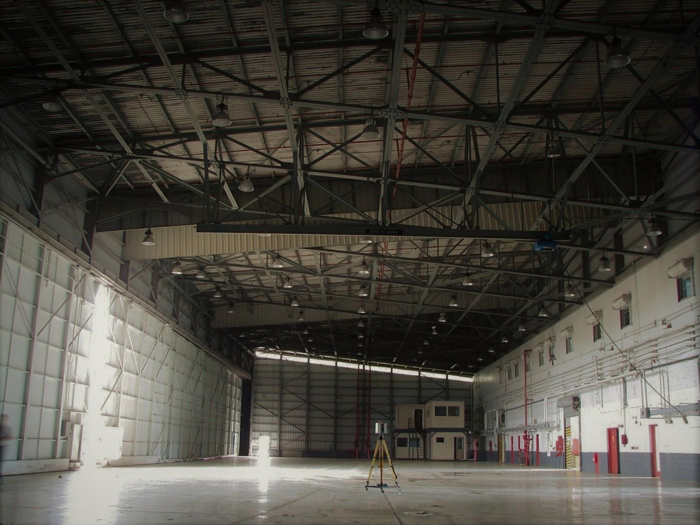Scanner mid-survey inside an aircraft hangar